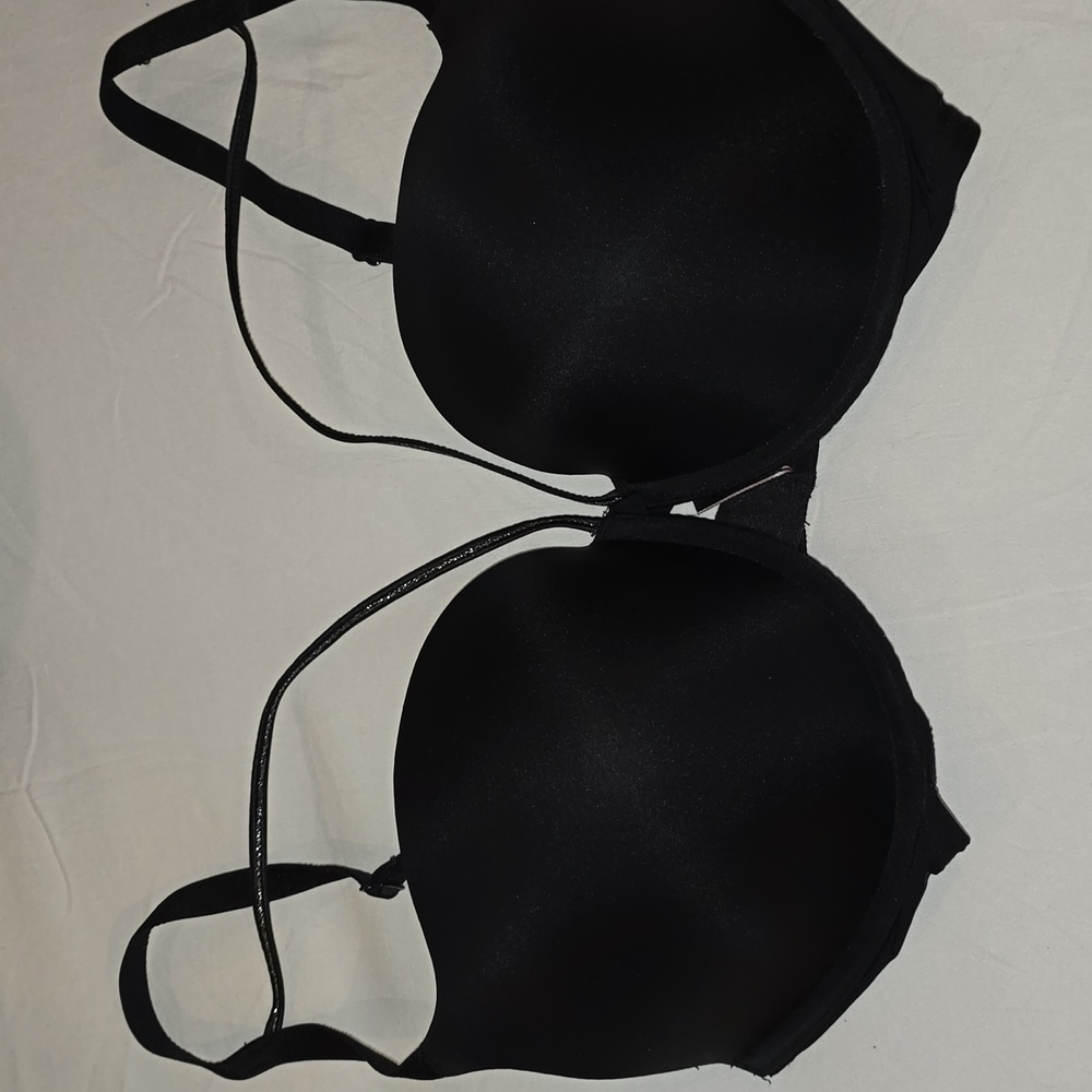 Victoria's Secret black push up bra with decorative strap above each cup.